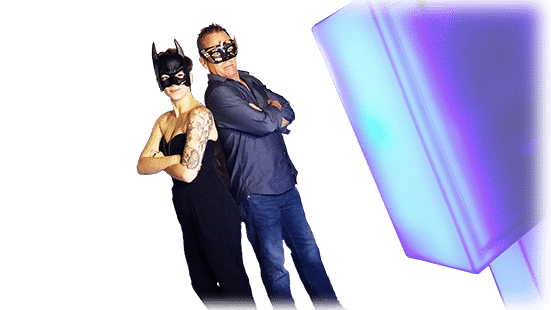 Two guests dressed up like superheroes using an open air photo booth